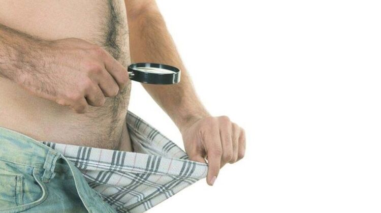 a man looks in his underpants and thinks about penis enlargement with soda